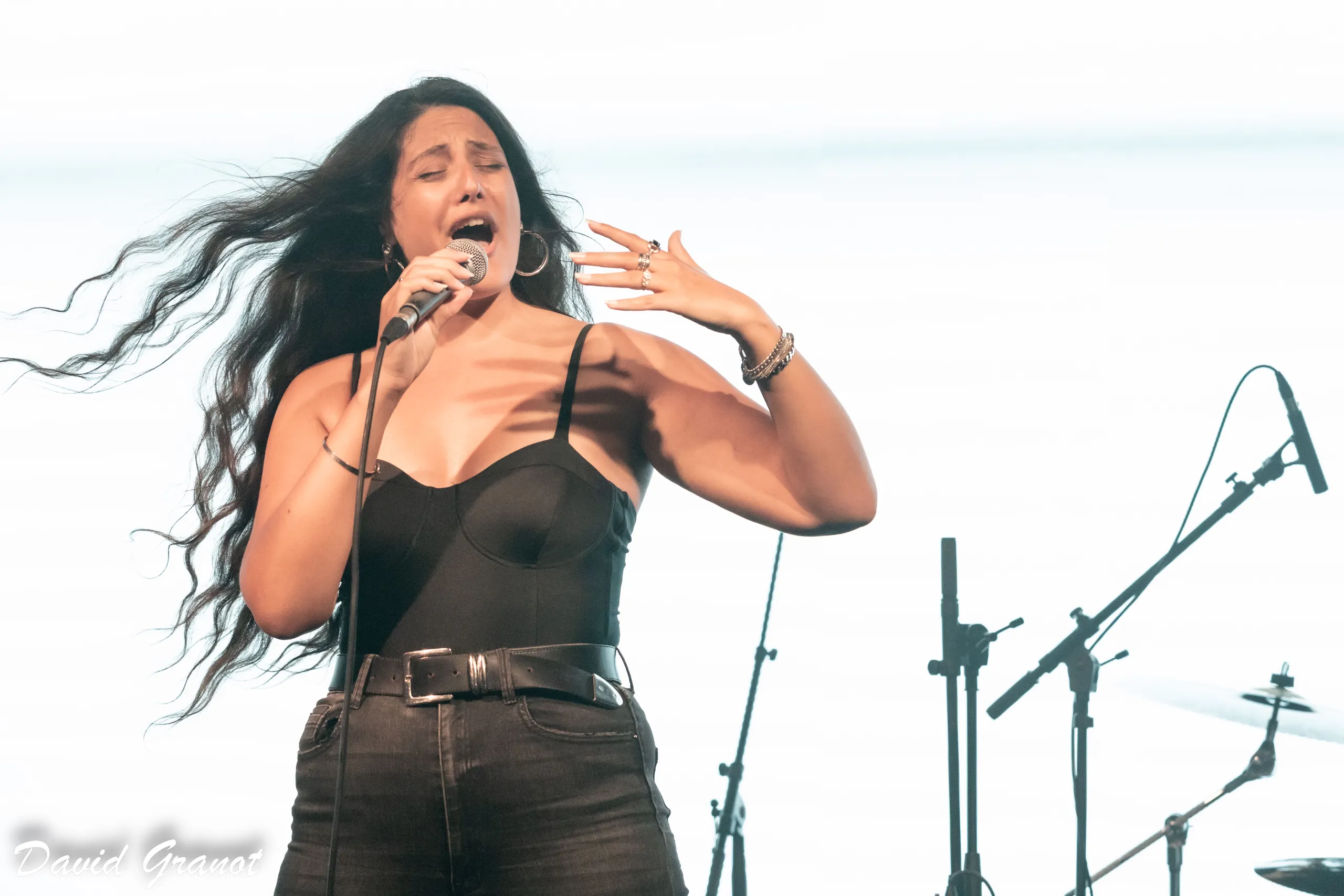 Nofar Cohen singing into the mic, her hair flying